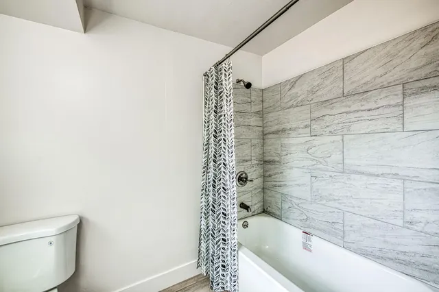 a bathroom with a bathtub and shower