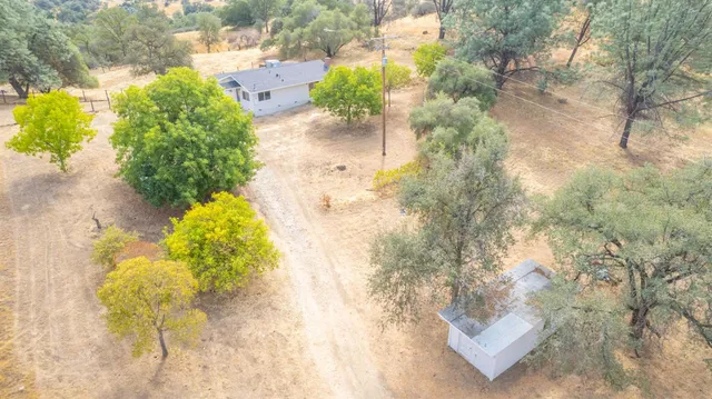 a view of a house with a yard covered in snow