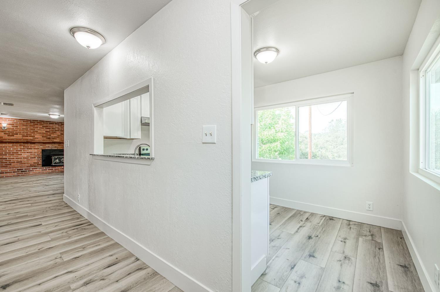 29531 Morgan Canyon Road Prather, CA 93651 - Photo 3 of 42 a view of a hallway with wooden floor and staircase