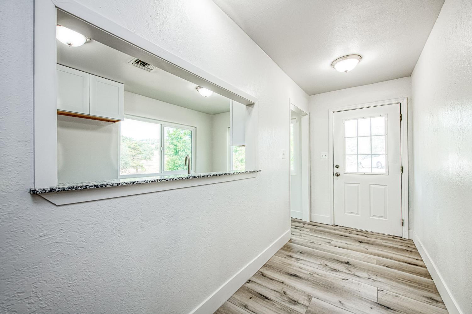29531 Morgan Canyon Road Prather, CA 93651 - Photo 4 of 42 a view of empty room with window and wooden floor