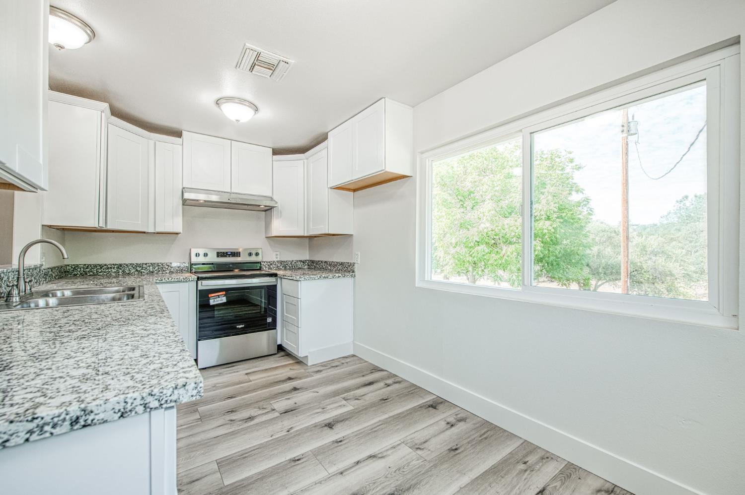 29531 Morgan Canyon Road Prather, CA 93651 - Photo 5 of 42 a kitchen with a stove a sink and a refrigerator