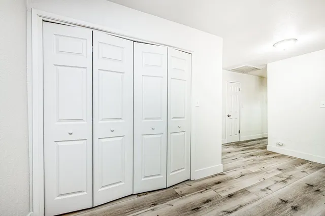 an empty room with wooden floor