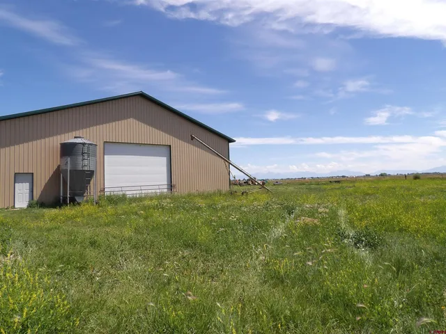 a backyard of a house with lots of green space and mountain view in back