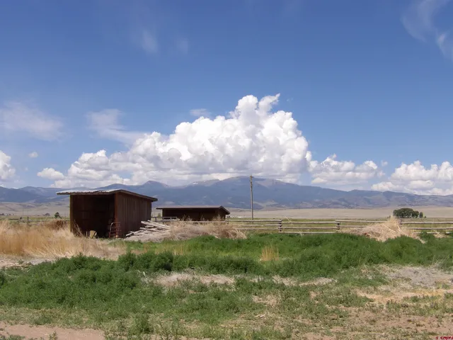 a view of a fountain in front of a big yard