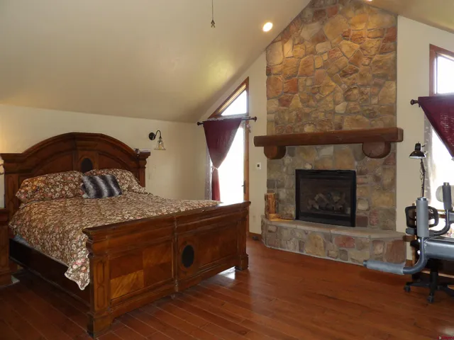 a bedroom with a bed and a fireplace