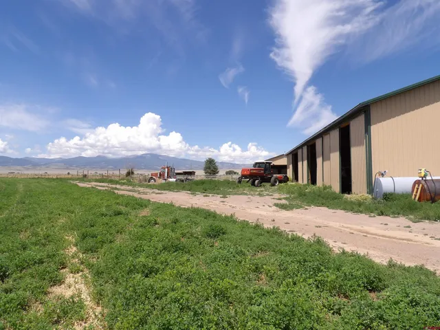 a view of a house with a yard and a garage