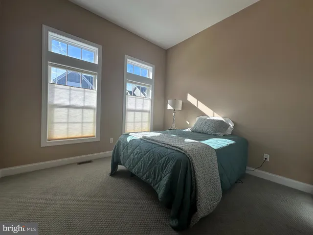 a spacious bedroom with a bed and window