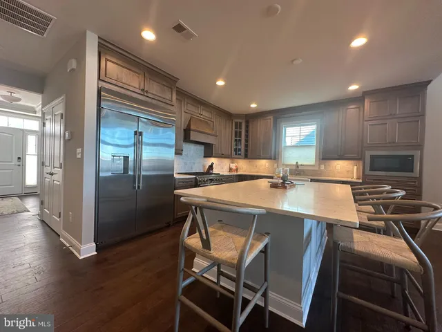 a stove top oven sitting inside of a kitchen and granite counter tops