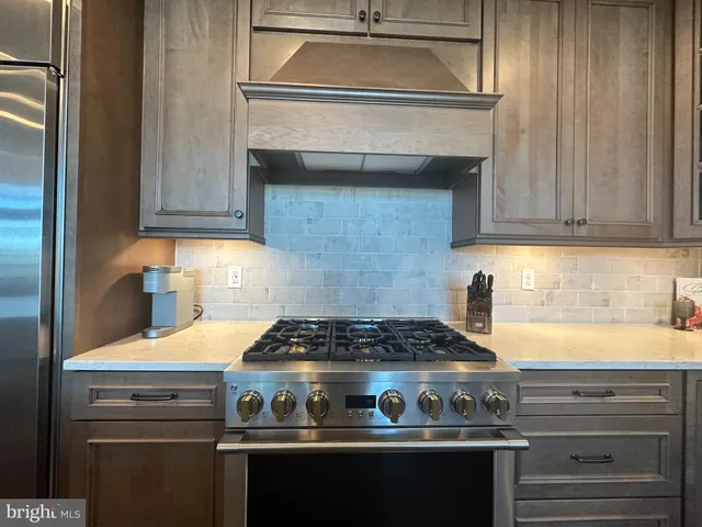a kitchen with a sink cabinets and wooden floor