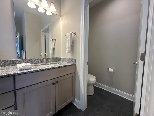 a bathroom with a double vanity sink a mirror and bathtub