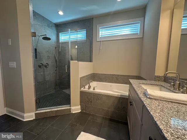 a bathroom with a shower and a sink