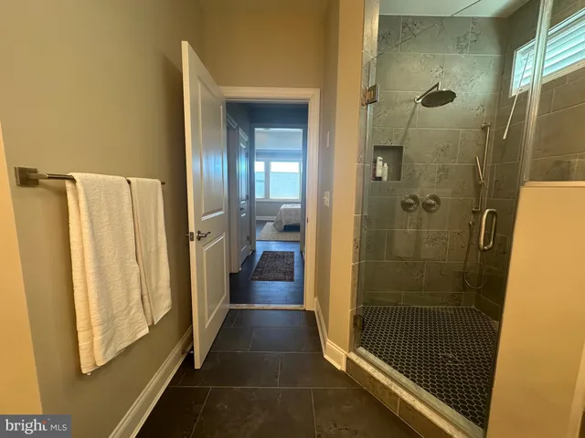 a view of a chairs with barbeque and wooden fence