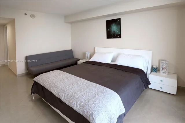 a bedroom with a bed and a couch