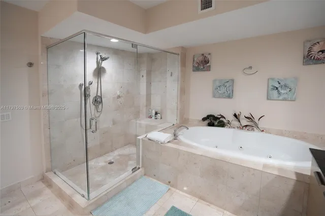 a bathroom with a bathtub a shower a sink and mirror