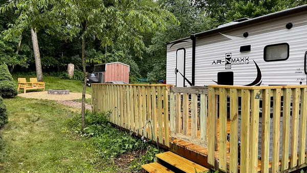 a front view of a house with garden and porch