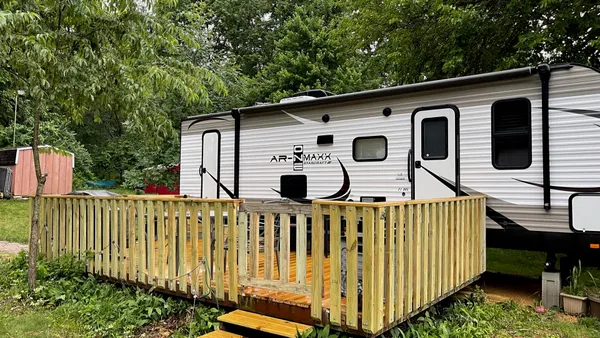 a front view of a house with wooden fence