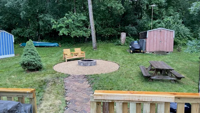 a view of a backyard with plants and a garden