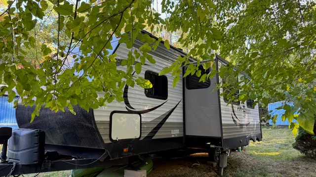 a backyard of a house with barbeque oven fire pit table and chairs