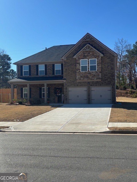 343 Jarrett Street, Unit 147 Fairburn, GA 30213 - Photo 2 of 22 a front view of a house with a yard