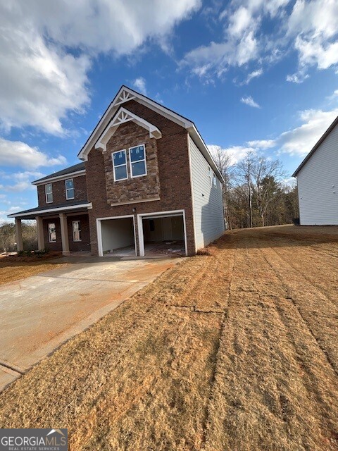343 Jarrett Street, Unit 147 Fairburn, GA 30213 - Photo 3 of 22 a front view of a house with a yard