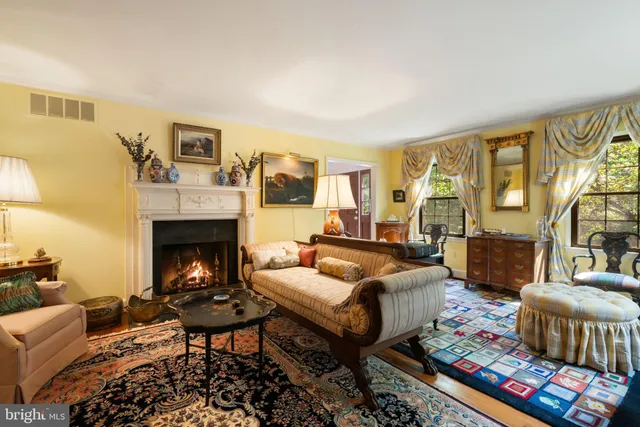 a living room with furniture fireplace and a table