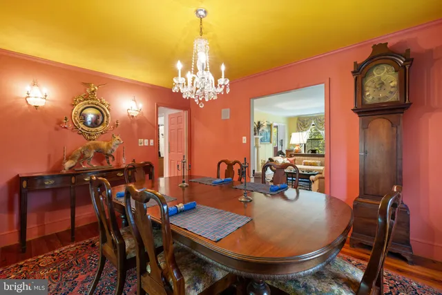 a view of a dining room with furniture and chandelier