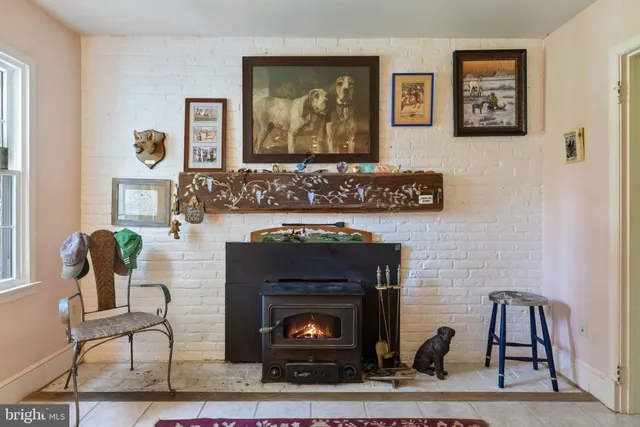 a living room with lots of furniture and a book shelf