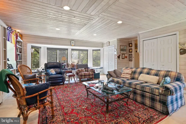 a view of a dining room with furniture large windows and wooden floor