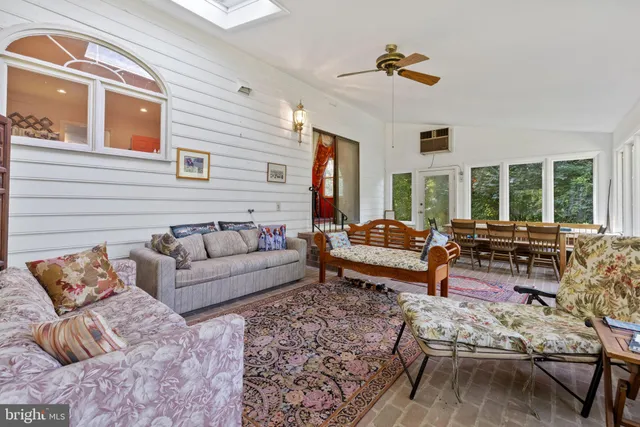 a living room with furniture and floor to ceiling windows