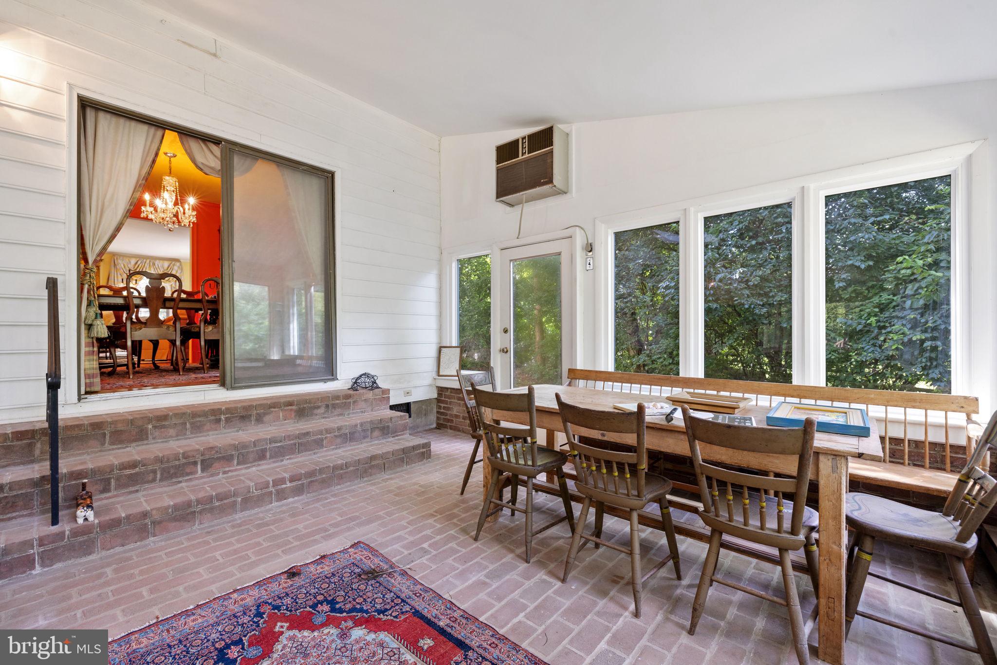 961 Summerville Road Boyce, VA 22620 - Photo 25 of 57 a view of a dining room with furniture large windows and wooden floor