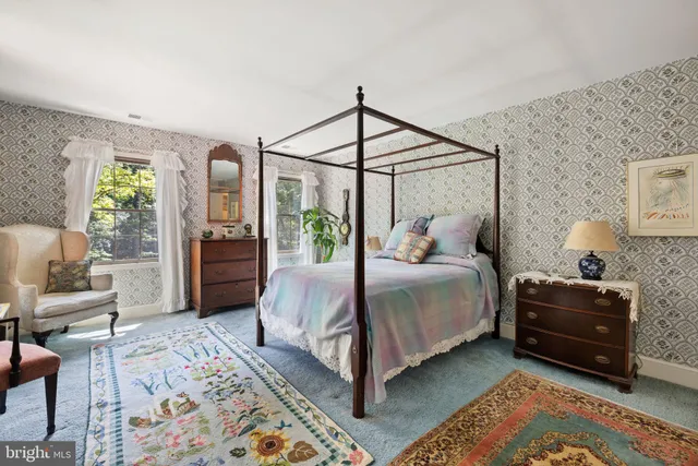 a bed room with a bed and a chair