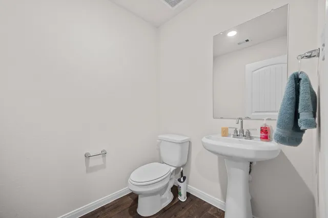 a bathroom with a sink toilet and a mirror