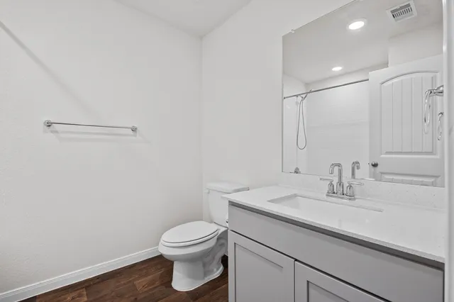 a bathroom with a sink a toilet and vanity