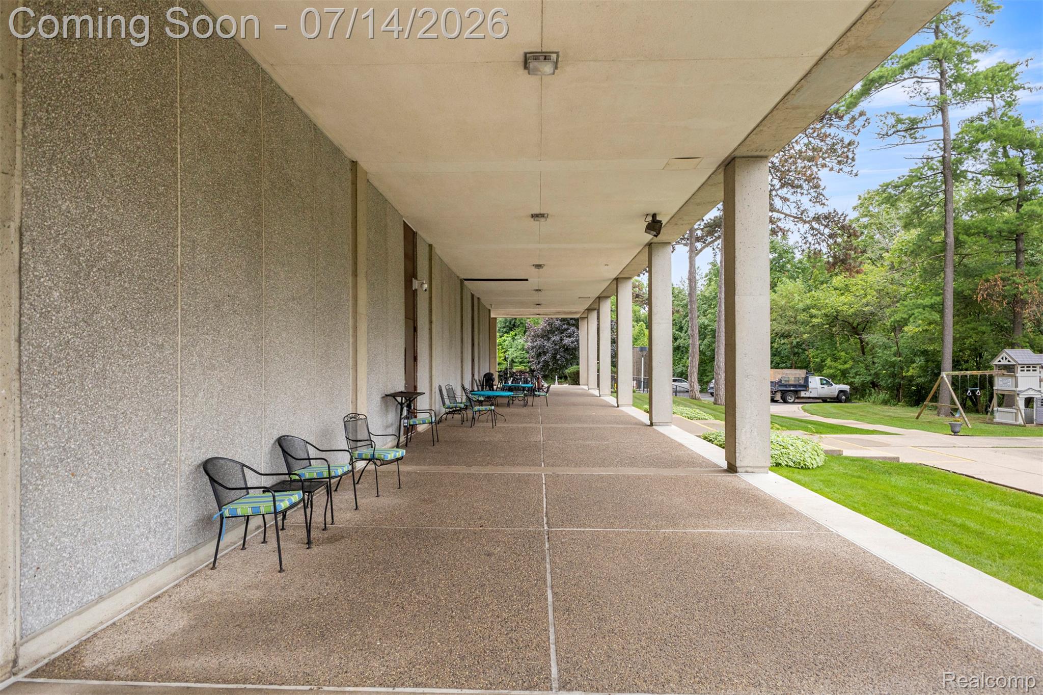 22700 Garrison Street, Unit 707 Dearborn, MI 48124 - Photo 21 of 22 Long, covered walkway featuring exposed aggregate concrete flooring