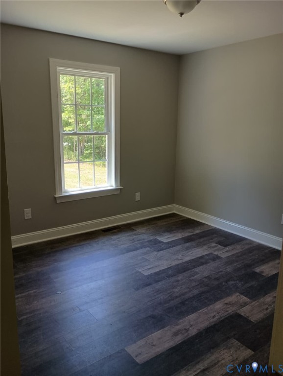 741 Grapevine Road Sandston, VA 23150 - Photo 14 of 16 an empty room with wooden floor and windows