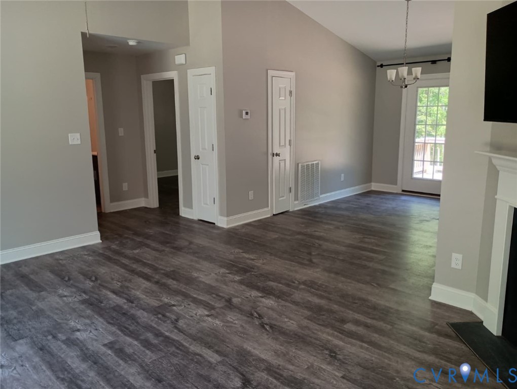 741 Grapevine Road Sandston, VA 23150 - Photo 5 of 16 an empty room with wooden floor and a window