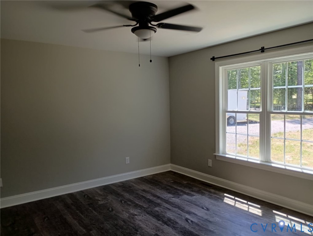741 Grapevine Road Sandston, VA 23150 - Photo 9 of 16 a view of an empty room with wooden floor and a window