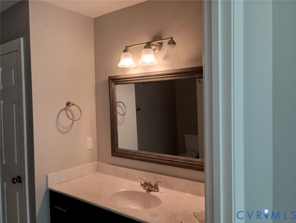 741 Grapevine Road Sandston, VA 23150 - Photo 10 of 16 a bathroom with a sink and a mirror