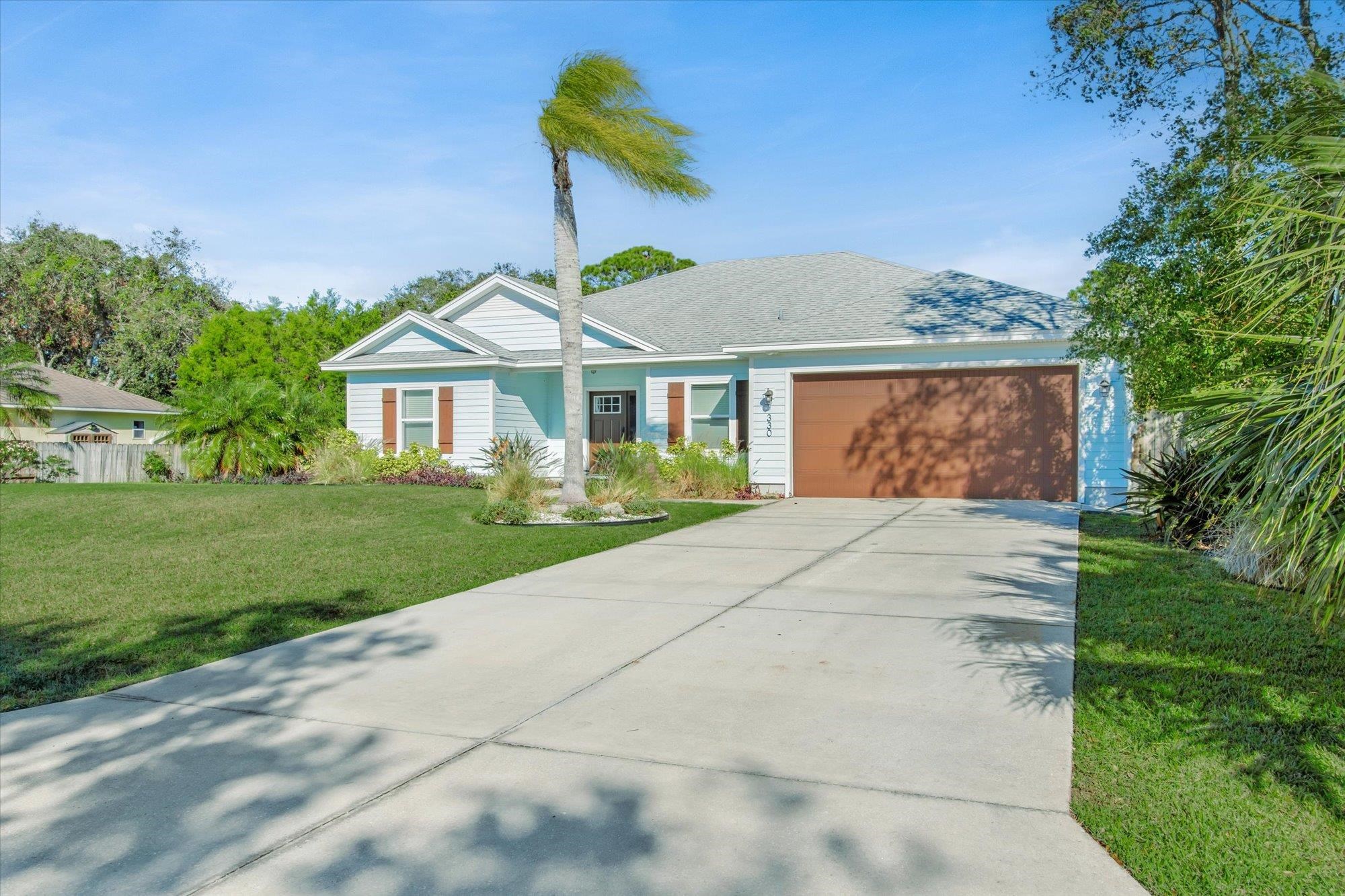 330 Biscayne Avenue St. Augustine, FL 32080 - Photo 4 of 49 a front view of a house with a yard and potted plants