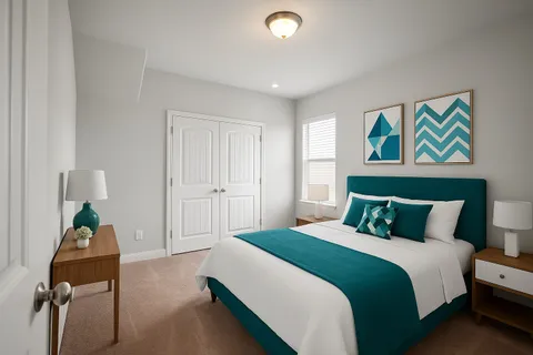 a bedroom with a bed and painting on the wall