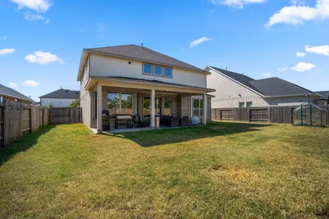 a view of a house with backyard and porch