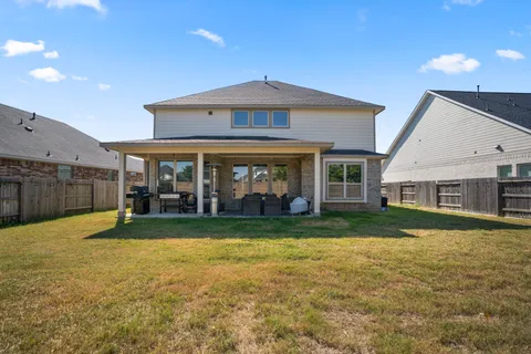 a view of a house with a yard and porch