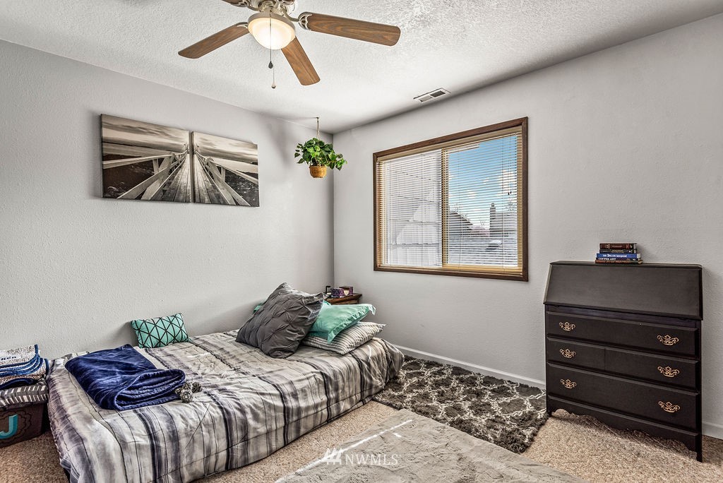2363 40th Avenue, Unit 7 Longview, WA 98632 - Photo 16 of 25 a bedroom with a bed and wooden floor