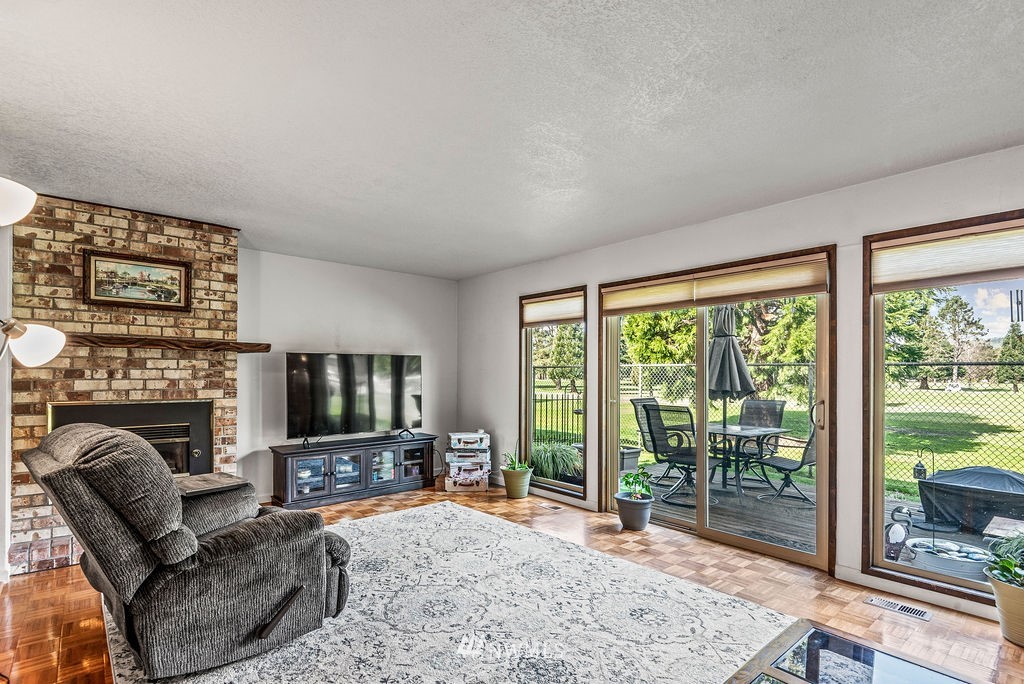 2363 40th Avenue, Unit 7 Longview, WA 98632 - Photo 3 of 25 a living room with furniture a flat screen tv and a fireplace