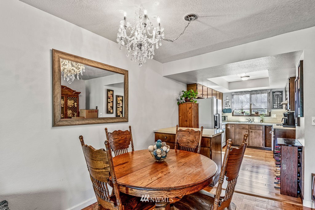 2363 40th Avenue, Unit 7 Longview, WA 98632 - Photo 5 of 25 a view of a dining room with furniture and chandelier