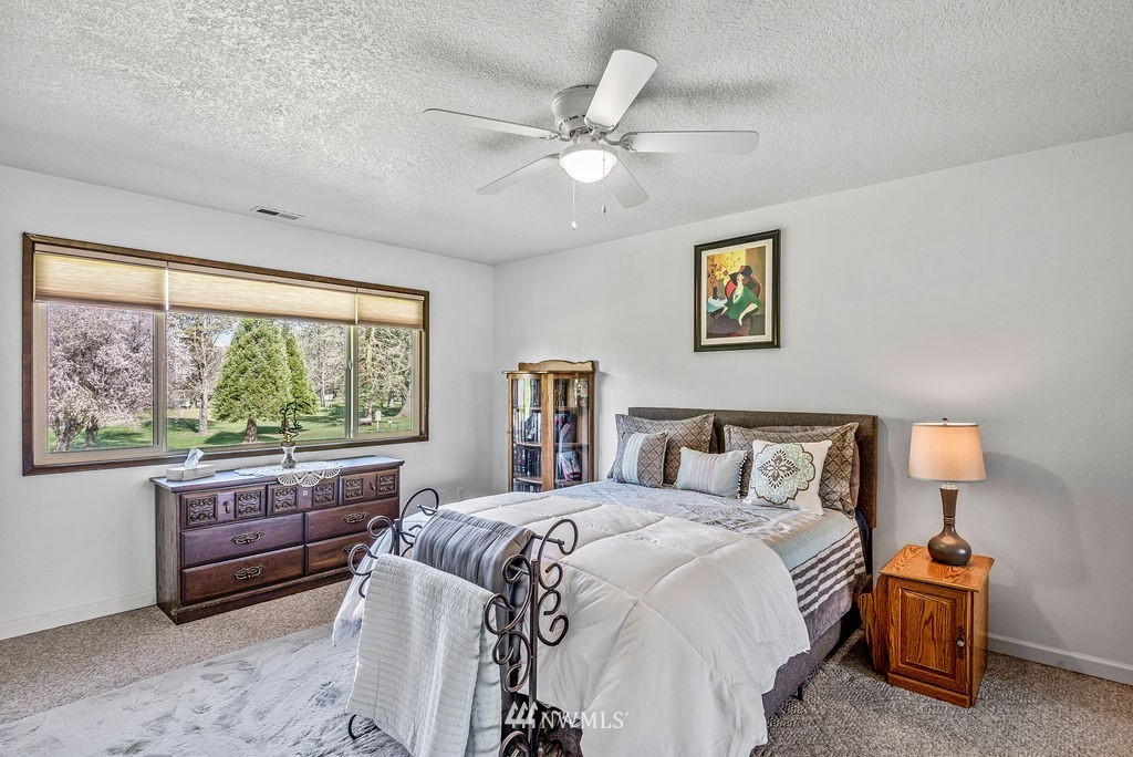 2363 40th Avenue, Unit 7 Longview, WA 98632 - Photo 9 of 25 a bedroom with a large bed and a large window