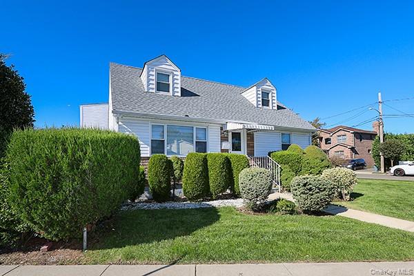 132 Bethel Road Albertson, NY 11507 - Photo 2 of 28 New england style home featuring a front yard and a shingled roof