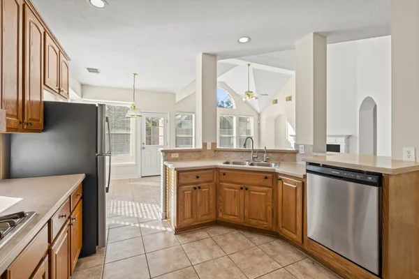 a kitchen with a sink a stove and cabinets