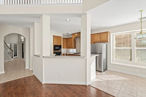 a kitchen with stainless steel appliances granite countertop a refrigerator and a stove top oven