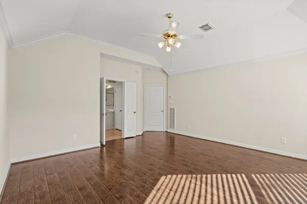 a view of an empty room with wooden floor